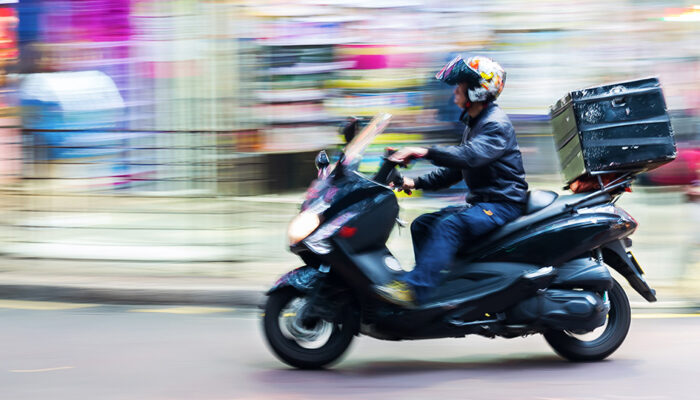 Courier delivering goods by scooter with optimal order routing