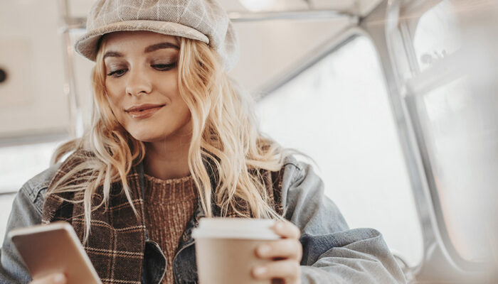 Lady with coffee using phone