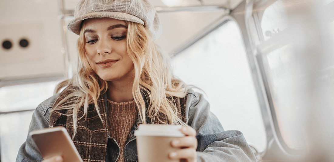 Lady with coffee using phone