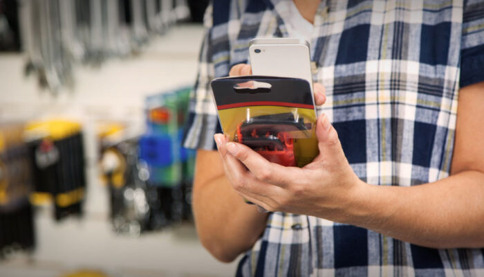 Personal shopper scans an item with a mobile phone