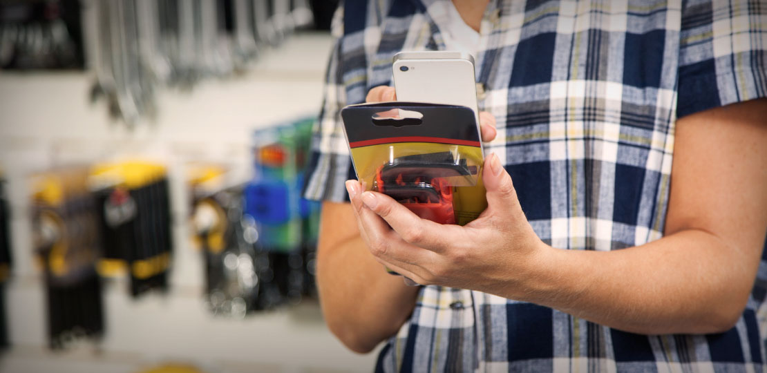 Personal shopper scans an item with a mobile phone