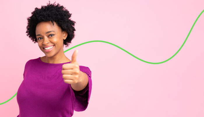 Woman in purple sweater giving a thumbs-up