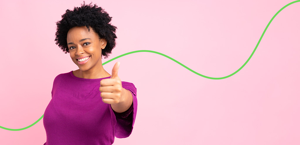Woman in purple sweater giving a thumbs-up
