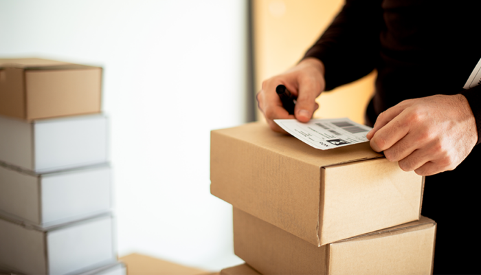 worker applying a shipping label